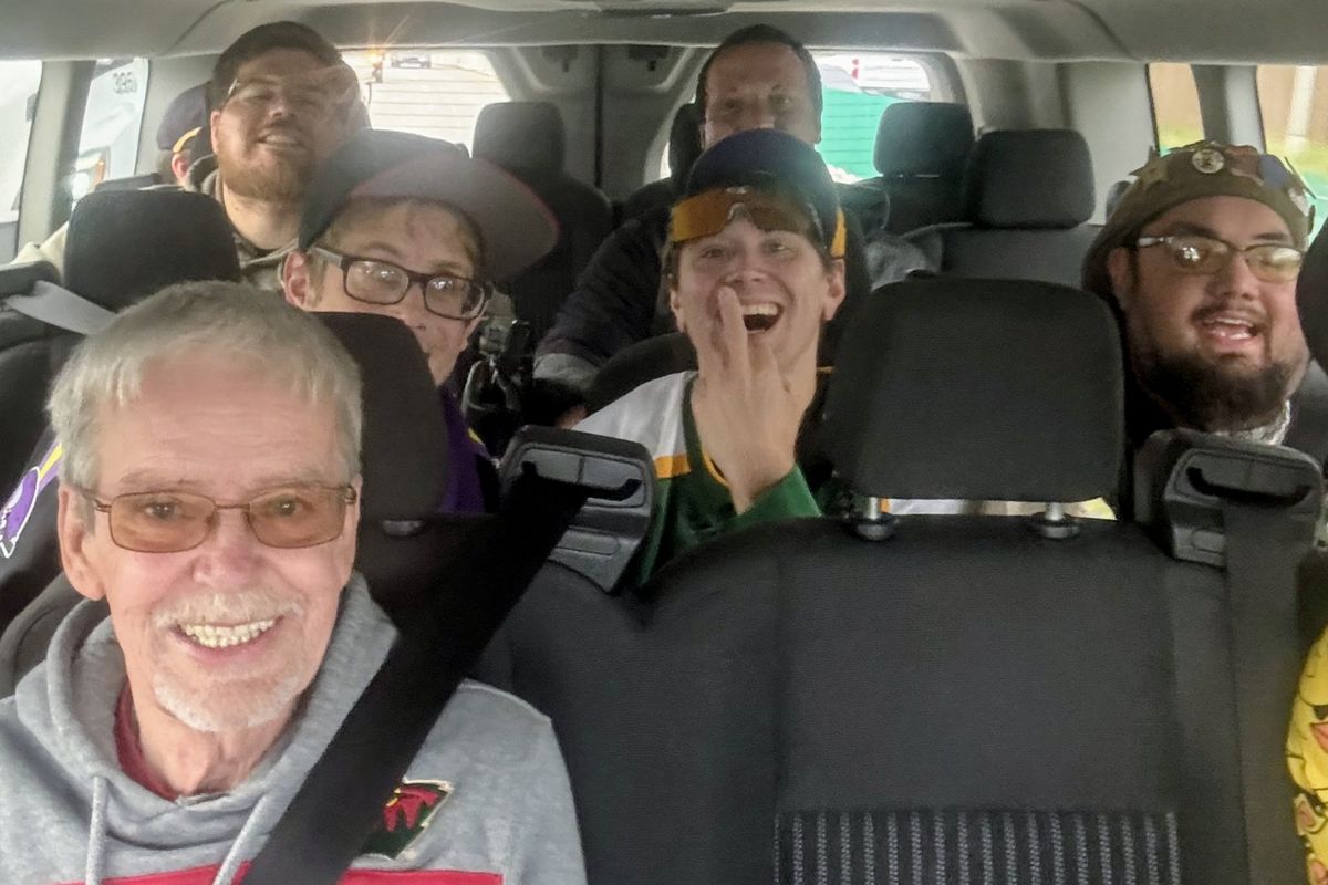 The crew smiling and laughing on the van ride to the game